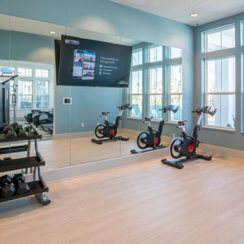a room with exercise equipment and a tv