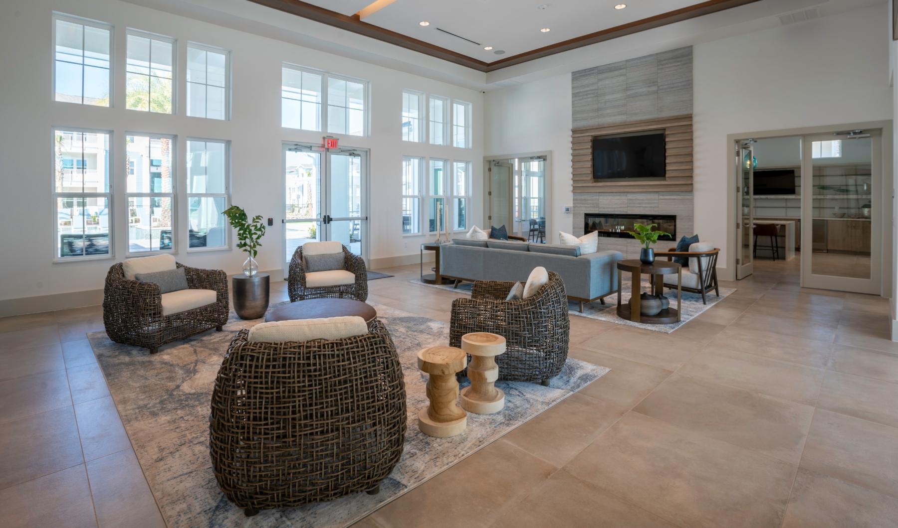 a large living room with a large rug and a large window