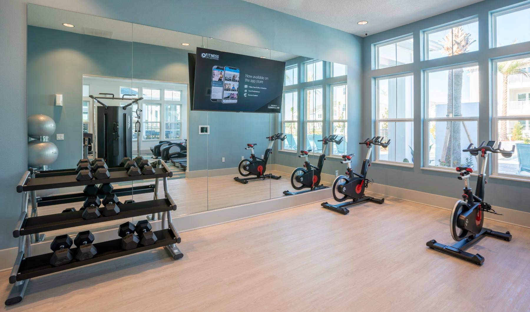 a room with exercise equipment and a tv