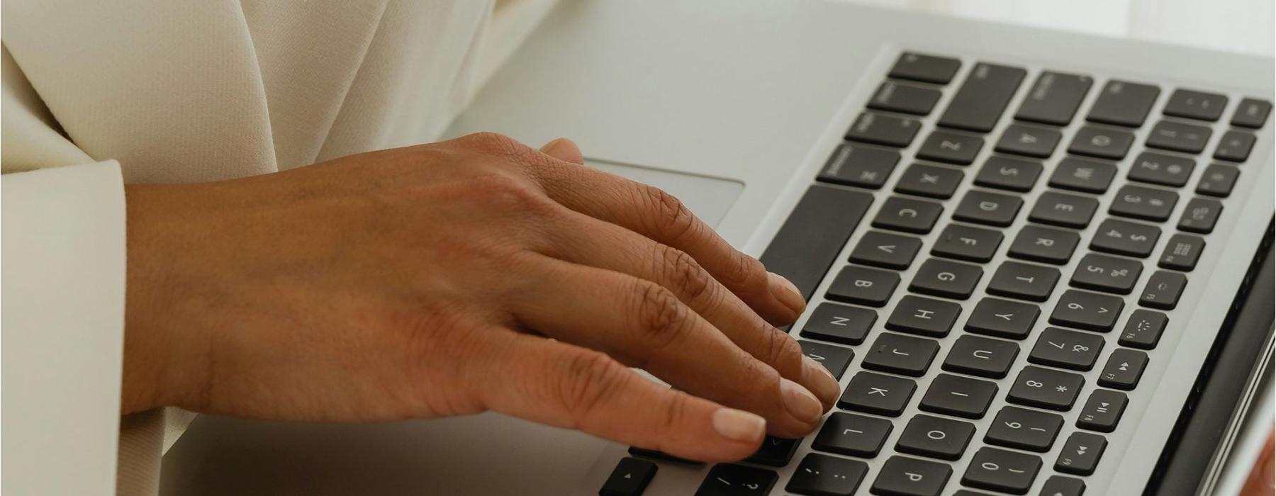 a person typing on a laptop