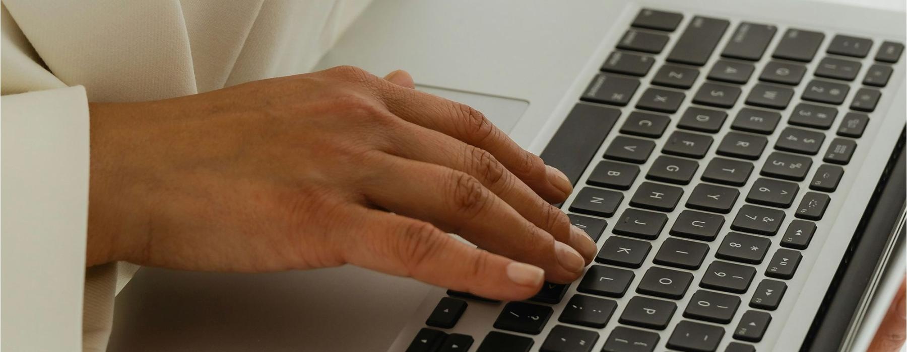 a person typing on a laptop